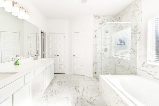 full bathroom featuring a bath, a marble finish shower, a sink, double vanity, and marble finish floor