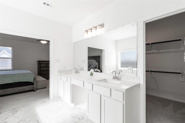 full bathroom featuring a sink, double vanity, plenty of natural light, ensuite bathroom, and visible vents
