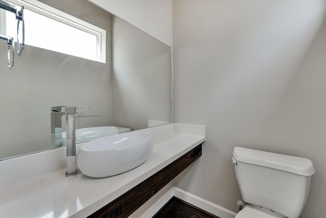 half bath featuring toilet and vanity