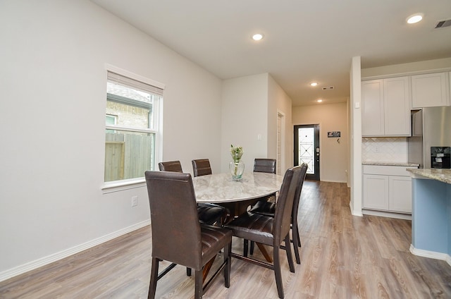 dining space featuring recessed lighting, baseboards, and light wood finished floors