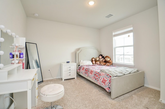 bedroom with baseboards, light carpet, and visible vents