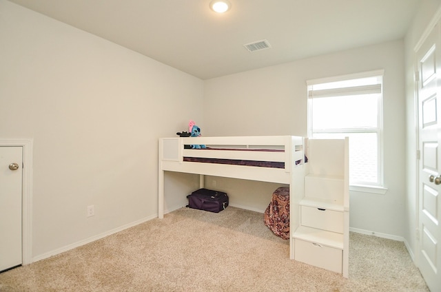 bedroom with baseboards, carpet flooring, and visible vents