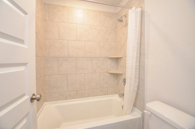 bathroom with shower / bath combination with curtain and toilet