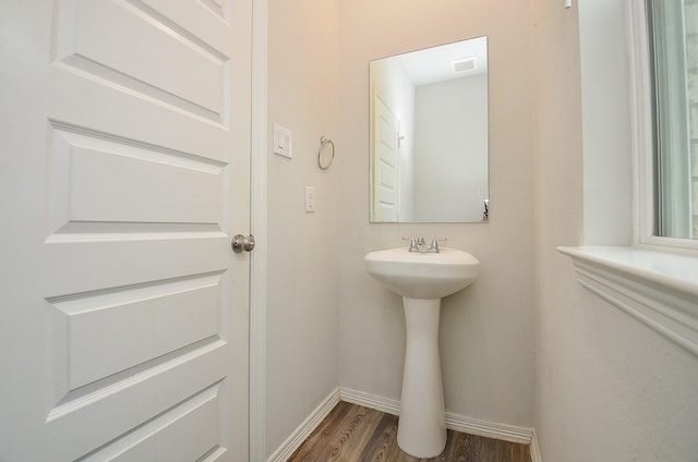 bathroom with baseboards, wood finished floors, and visible vents
