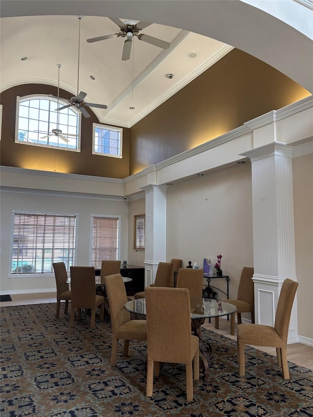 dining area featuring high vaulted ceiling, baseboards, a ceiling fan, and decorative columns
