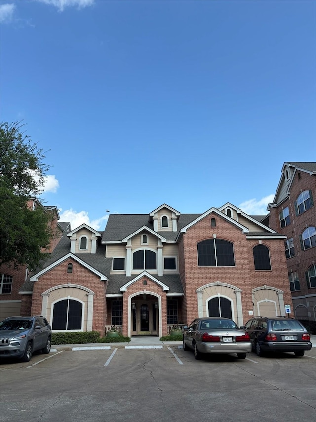 view of building exterior with uncovered parking