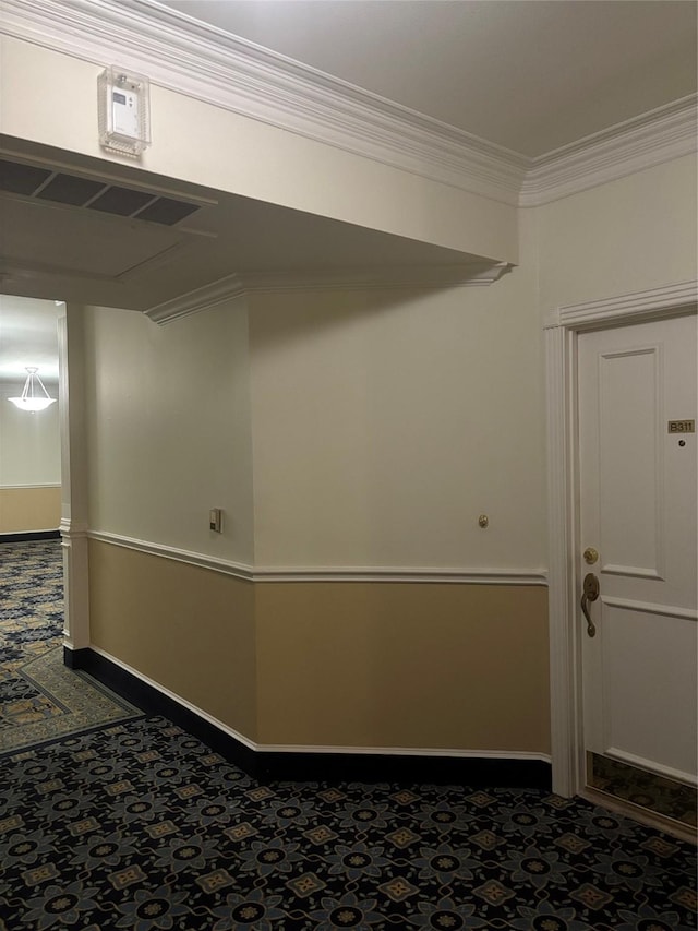 interior space with baseboards and ornamental molding