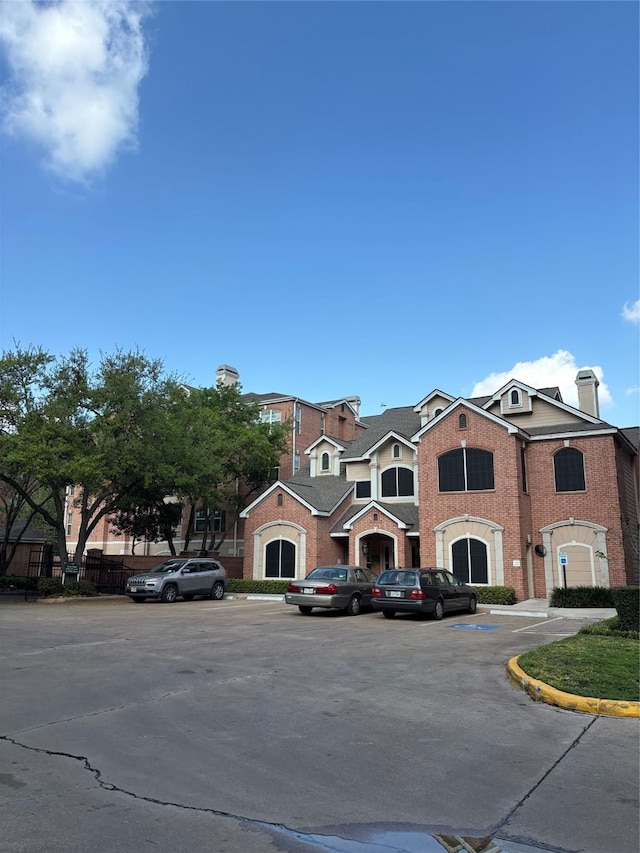 view of property featuring uncovered parking
