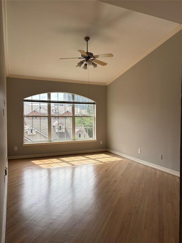 unfurnished room with baseboards, ornamental molding, ceiling fan, and wood finished floors