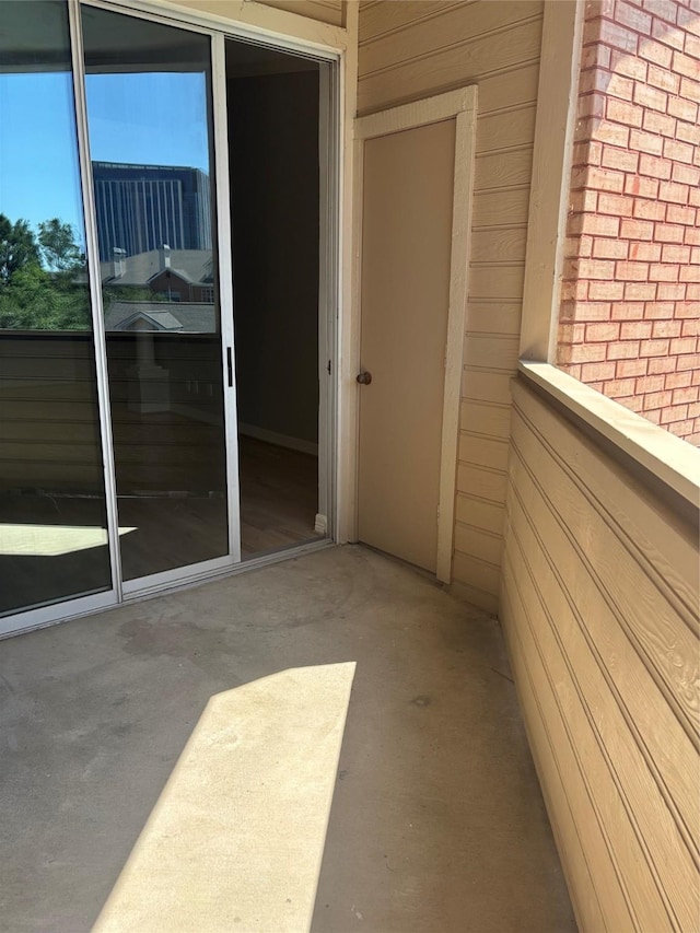 view of exterior entry with brick siding