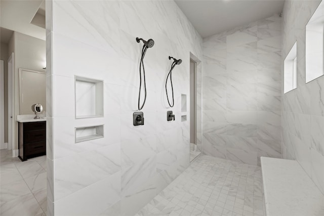 bathroom with vanity and tiled shower
