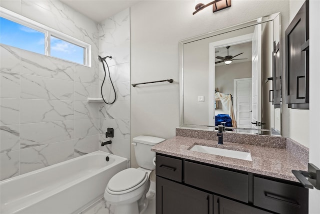 ensuite bathroom featuring a ceiling fan, shower / bathing tub combination, vanity, marble finish floor, and toilet