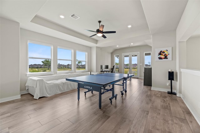 playroom with wood finished floors, ceiling fan, a raised ceiling, visible vents, and recessed lighting