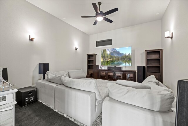 home theater room with dark carpet and ceiling fan