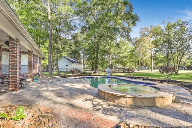 view of pool featuring a ceiling fan, a patio area, a pool with connected hot tub, and fence