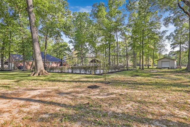 view of yard featuring a garage and an outdoor structure