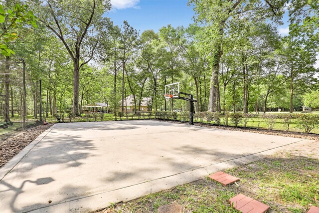 view of sport court featuring basketball hoop
