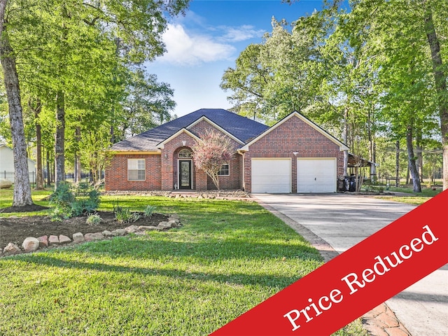 ranch-style home featuring a front yard, a garage, concrete driveway, and brick siding