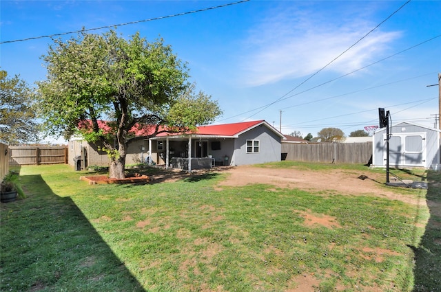 view of yard featuring an outdoor structure, a storage unit, and a fenced backyard
