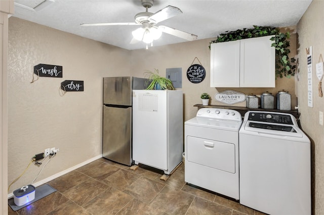 washroom with a ceiling fan, electric panel, baseboards, separate washer and dryer, and cabinet space