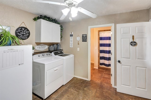 laundry room featuring washing machine and clothes dryer, a textured ceiling, ceiling fan, and cabinet space