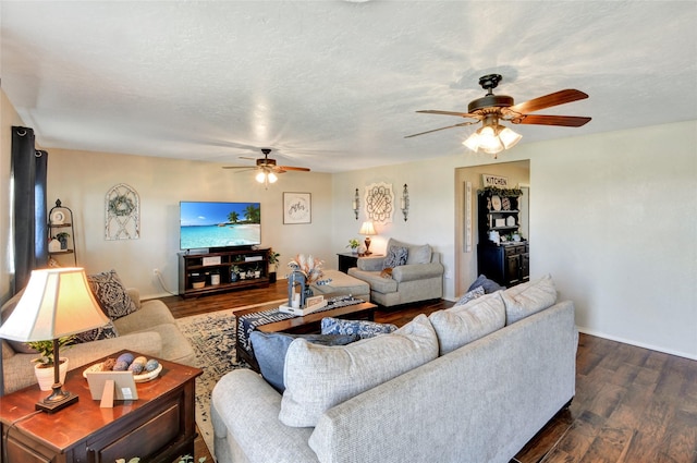 living room featuring dark wood finished floors, a ceiling fan, and baseboards