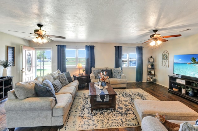 living room featuring wood finished floors, a healthy amount of sunlight, and a ceiling fan