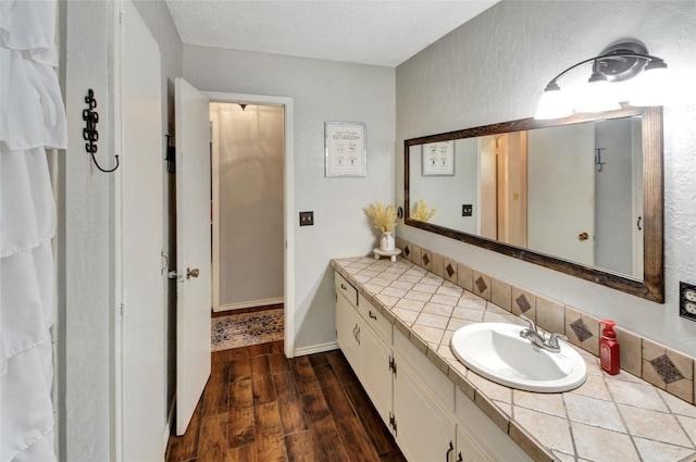 bathroom featuring wood finished floors and vanity