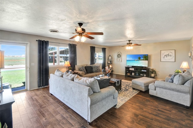 living room with dark wood-style floors, a textured ceiling, and ceiling fan