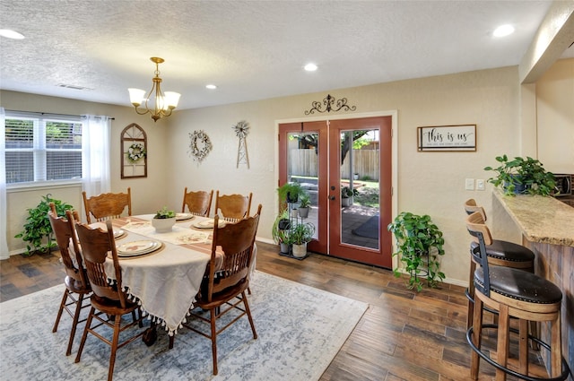 dining room featuring a chandelier, visible vents, baseboards, and french doors