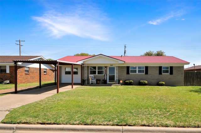 ranch-style home with brick siding, driveway, an attached carport, and a front yard