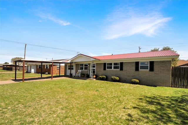 single story home with brick siding, fence, an attached carport, and a front yard