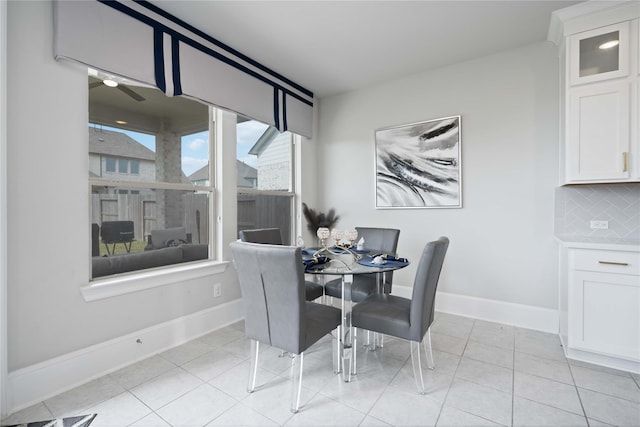 dining room featuring light tile patterned flooring and baseboards