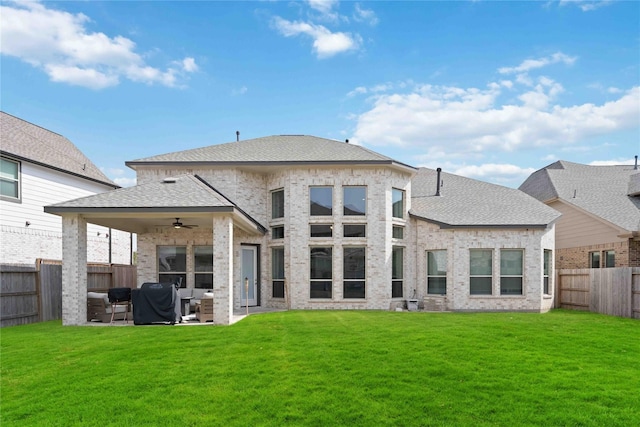 back of property with ceiling fan, a fenced backyard, an outdoor hangout area, a patio area, and a lawn