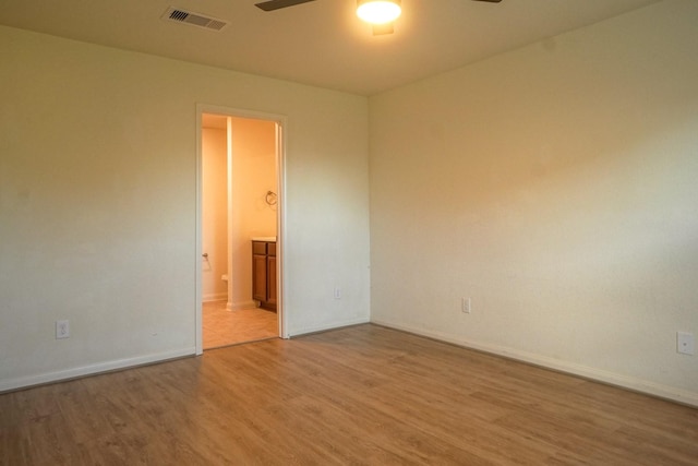 unfurnished room with light wood-style flooring, ceiling fan, and baseboards