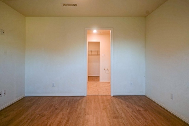 unfurnished room featuring wood finished floors and baseboards