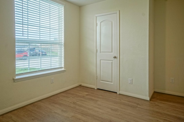 unfurnished room featuring light wood-style floors and baseboards