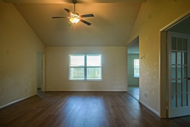unfurnished room featuring vaulted ceiling, wood finished floors, ceiling fan, and baseboards