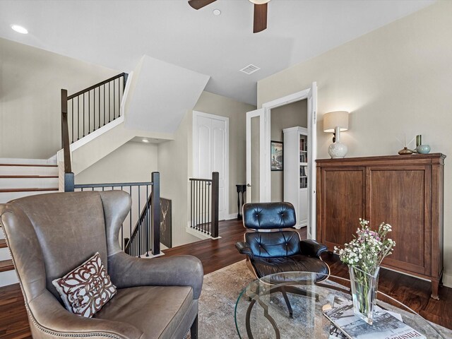 sitting room with wood finished floors, ceiling fan, an upstairs landing, baseboards, and visible vents