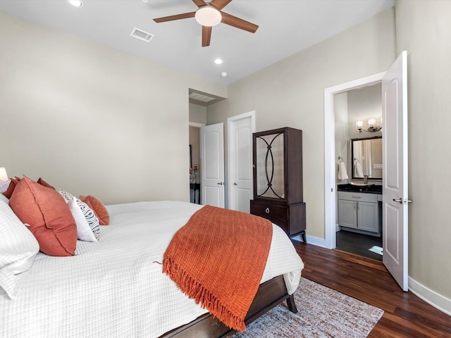 bedroom with baseboards, ensuite bath, dark wood-style flooring, visible vents, and recessed lighting