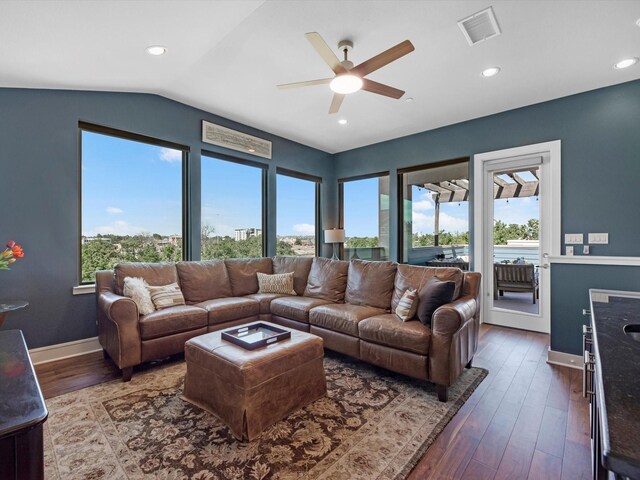 living area with lofted ceiling, visible vents, ceiling fan, baseboards, and wood-type flooring