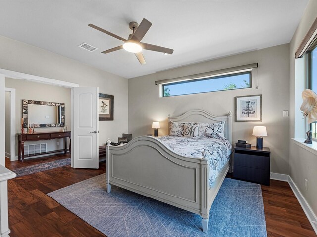 bedroom featuring wood finished floors, visible vents, ceiling fan, and baseboards
