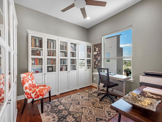 office space with wood finished floors, ceiling fan, and baseboards