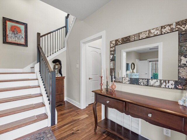interior space with stairs, baseboards, and dark wood finished floors