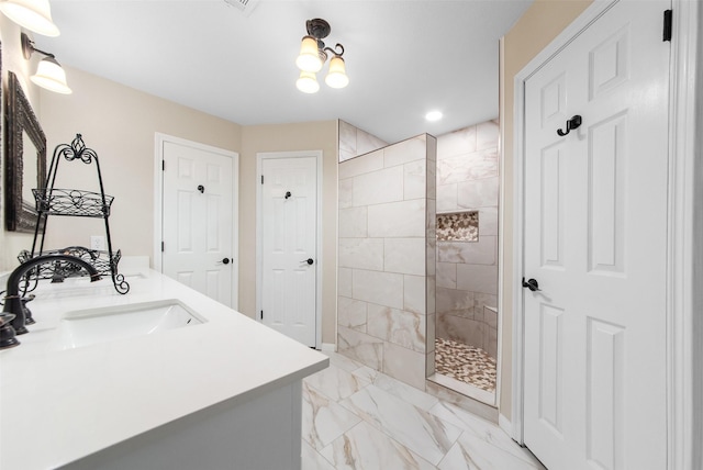 bathroom featuring recessed lighting, marble finish floor, double vanity, a walk in shower, and a sink