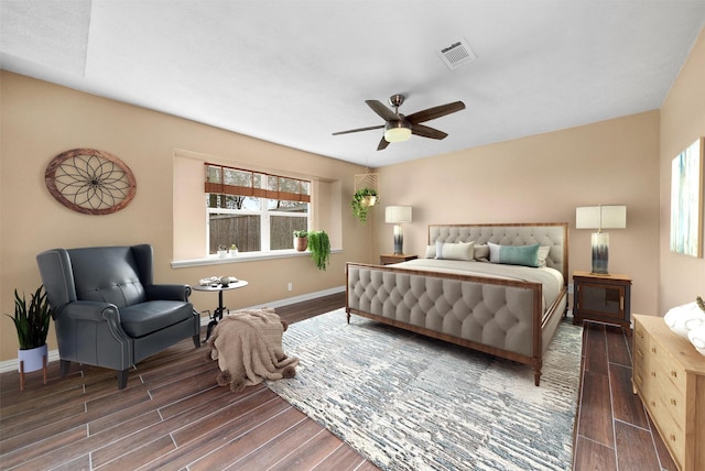 bedroom featuring ceiling fan, baseboards, wood finished floors, and visible vents