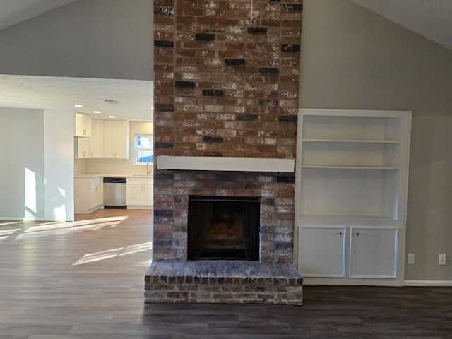 1403 Hitherfield Dr, Sugar Land, TX 77498 - unfurnished living room featuring wood finished floors, lofted ceiling, a fireplace, and baseboards