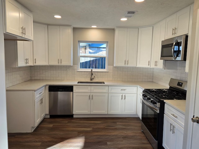 1403 Hitherfield Dr, Sugar Land, TX 77498 - kitchen with stainless steel appliances, a sink, white cabinetry, light countertops, and recessed lighting