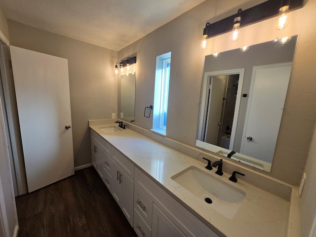 1403 Hitherfield Dr, Sugar Land, TX 77498 - bathroom with wood finished floors, double vanity, and a shower
