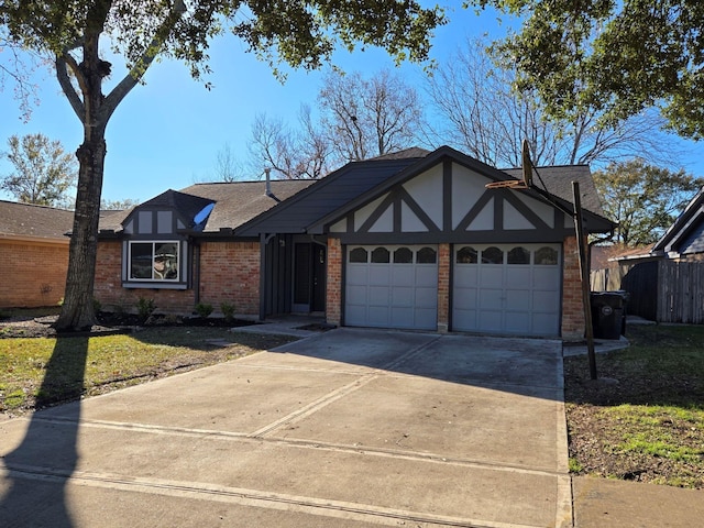 1403 Hitherfield Dr, Sugar Land, TX 77498 - tudor-style house with an attached garage, brick siding, driveway, and roof with shingles